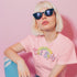 An election 2024 t-shirt with a colorful retro-style graphic that reads "Childless Cat Lady" across the chest. The text is in a playful, curvy font with each word in a different color - "Childless" in yellow-green, "Cat" in pink, and "Lady" in purple. Small cat face icons are incorporated into the letters 'a' in "Cat" and "Lady".